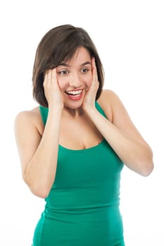 Young woman amazed and holding her face with her hands, isolated on white