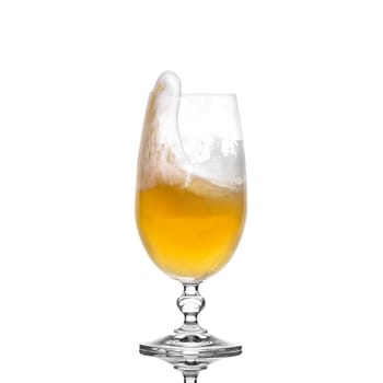 Splashing beer in a glass with little foam