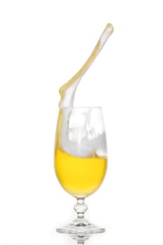 Splashing beer in a glass with little foam