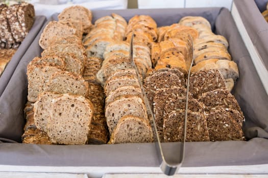 Slices of bread for a buffet with pliers