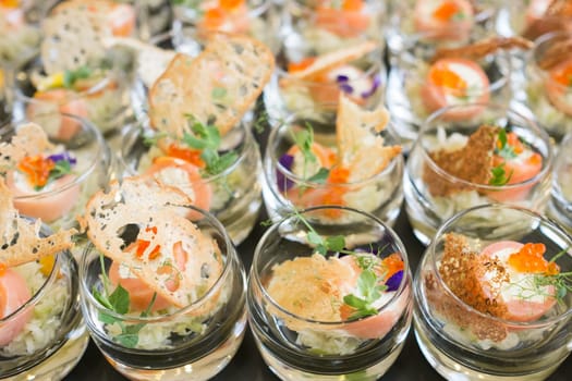 Glasses of salmon cream cheese and caviar