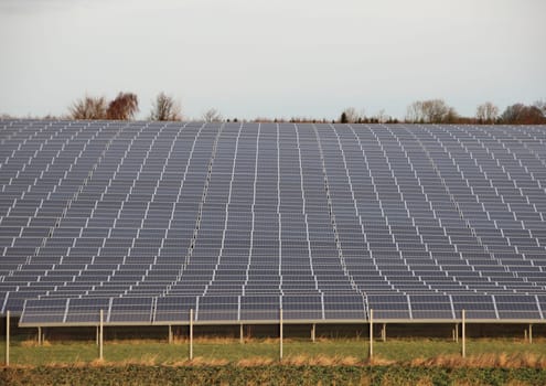 Sun Solar Industrial Plant with Fence Grass and Horizon