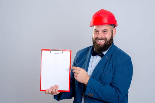 portrait of a young architect with red helmet and clipboard