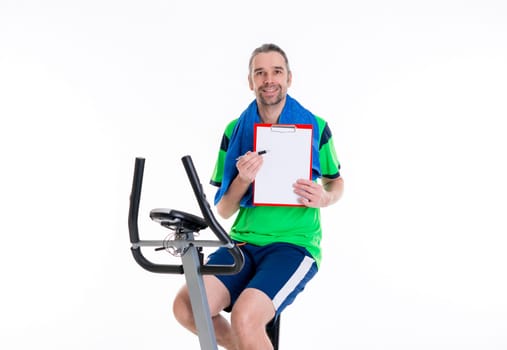 young man with clipboard train on fitness machine