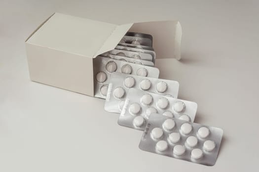 Multiple Loafs of Tablets Getting Out Form the Box over gray background with shadow.