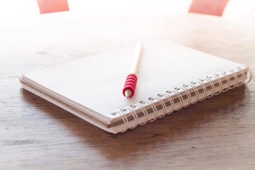 Work station with notebook and pencil with vintage filter, stock photo