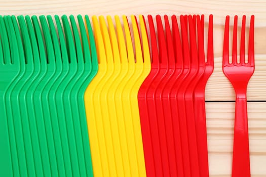 plastic colorful forks on wood background