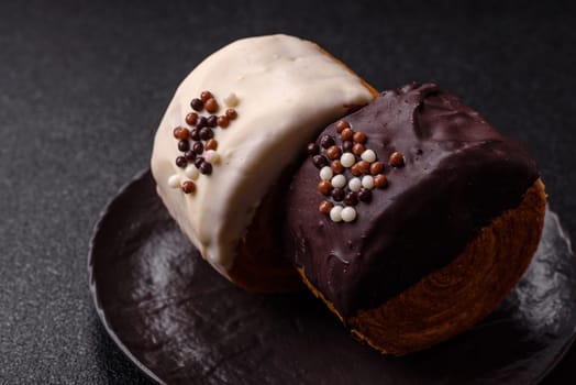 Round sweet New York roll croissant with chocolate cream filling on a dark concrete background