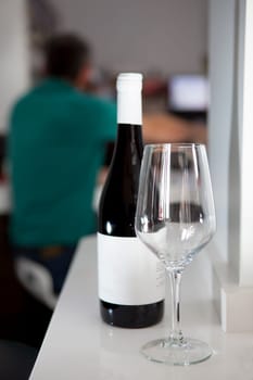 Glass of red wine with bottle over a restaurant table