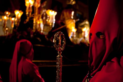 Bearer or nazareno holding a silver cane at Holy Week Procession, Spain