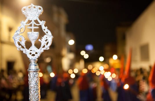 Bearer or nazareno holding a silver cane at Holy Week Procession, Spain