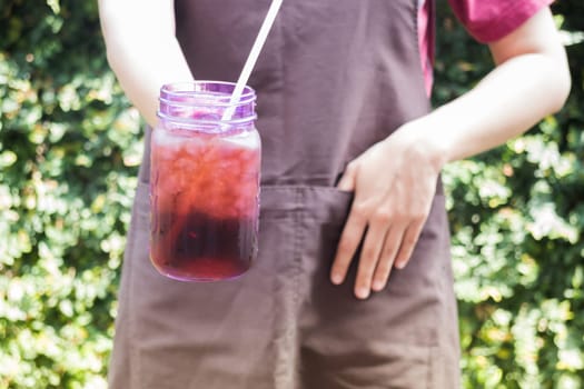 Barista serving iced black coffee, stock photo
