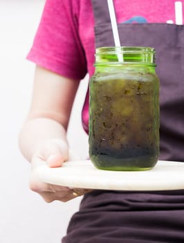 Barista serving iced black coffee, stock photo