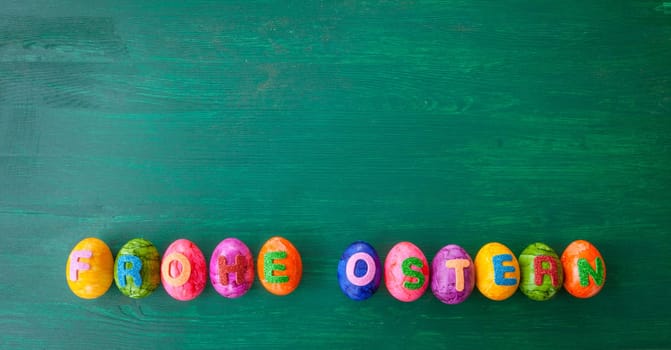 Colorful Easter eggs with Happy Easter lettering on green background