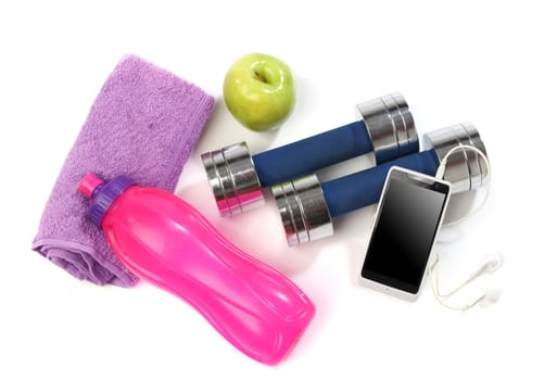 Fitness concept with a bottle of water, a towel, dumbbells, apples and a smartphone isolated