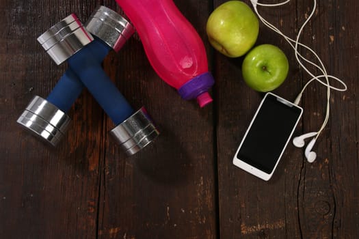 Fitness concept. Various elements over a wooden background