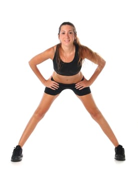 Happy young woman holding doing exercise and stretching over white