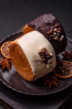 Round sweet New York roll croissant with chocolate cream filling on a dark concrete background