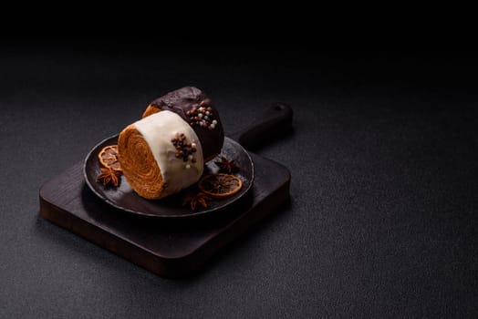 Round sweet New York roll croissant with chocolate cream filling on a dark concrete background