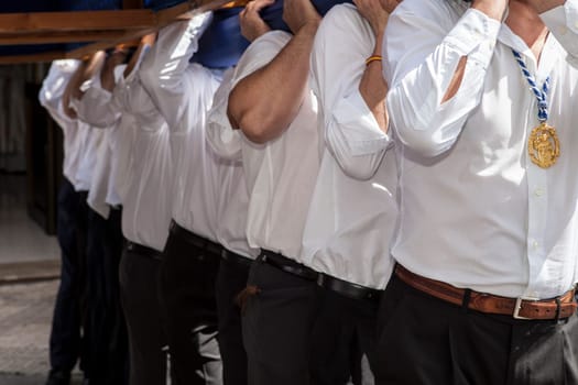 Costaleros carriying a float during the Holy Week Procession, Spain