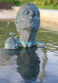 Swimmer statue of bronze woman on a fountain in Barcelona, Spain