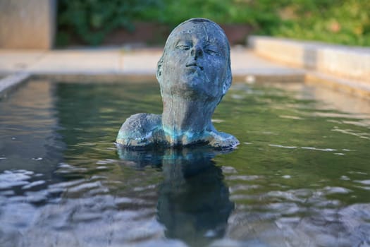Swimmer statue of bronze woman on a fountain in Barcelona, Spain