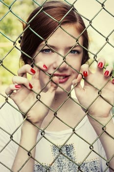 charming girl teen posing outdoors in bright sunlight