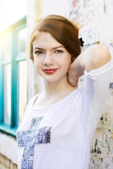 charming girl teen posing outdoors in bright sunlight