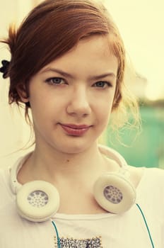 charming girl teen posing outdoors in bright sunlight