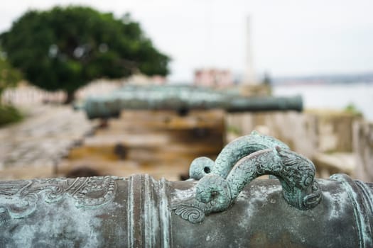 detail of old antique cannons guarding the waterfront