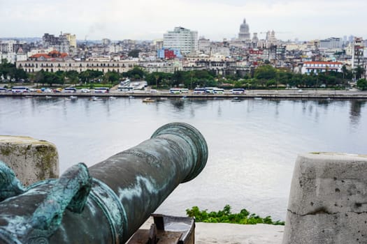 detail of old antique cannon overlooking the blurring city of havana, Cuba