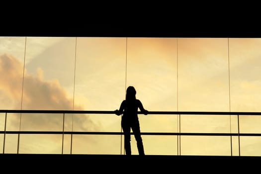 woman in the modern buildind at sunset