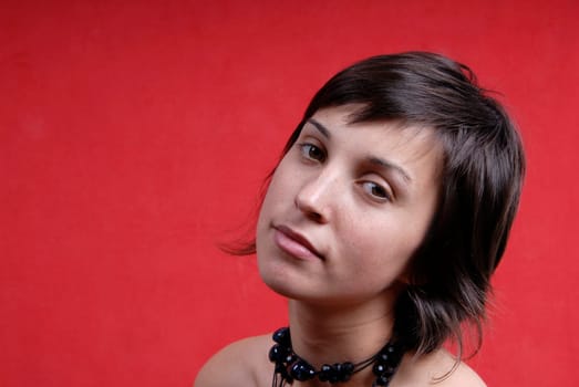 young woman portrait isolated on red background
