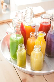 Various colorful smoothies in small bottles