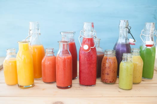 Various colorful smoothies in small bottles