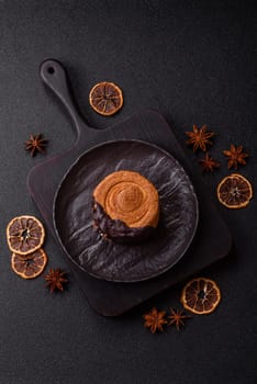 Round sweet New York roll croissant with chocolate cream filling on a dark concrete background