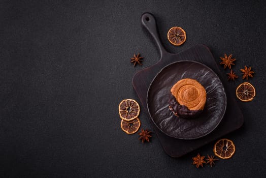 Round sweet New York roll croissant with chocolate cream filling on a dark concrete background