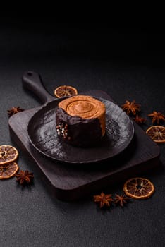 Round sweet New York roll croissant with chocolate cream filling on a dark concrete background