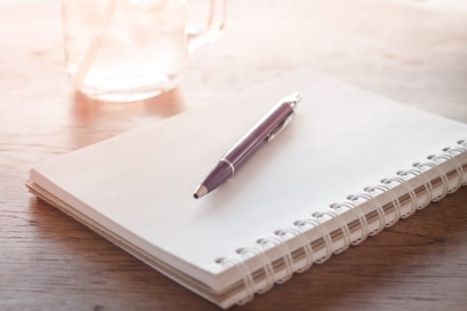 Work station with notebook and pen with vintage filter