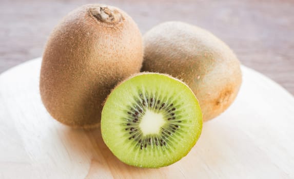 Kiwi fruit on brown wooden background, stock photo