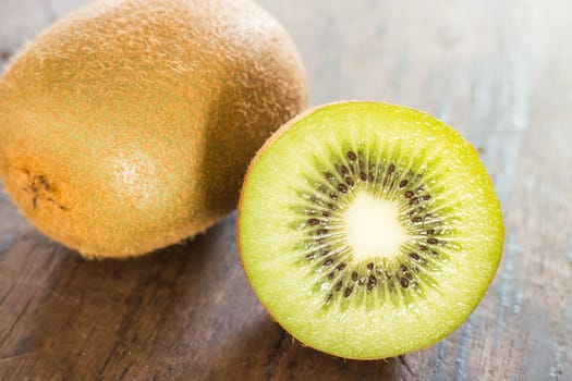 Kiwi fruit on brown wooden background, stock photo