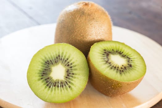 Kiwi fruit on brown wooden background, stock photo