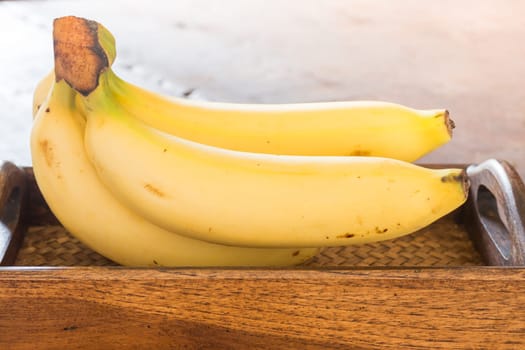 Banana on brown wooden background, stock photo