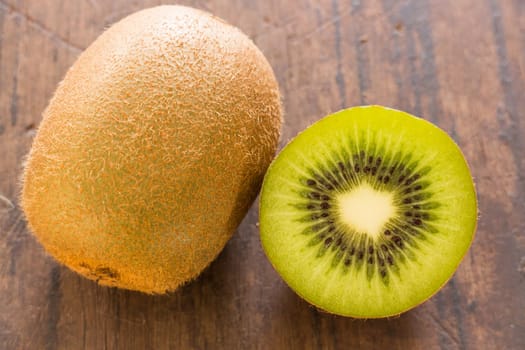 Kiwi fruit on brown wooden background, stock photo