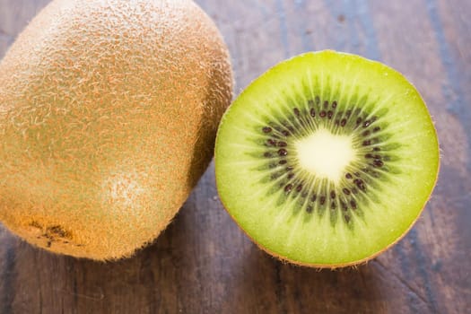 Kiwi fruit on brown wooden background, stock photo