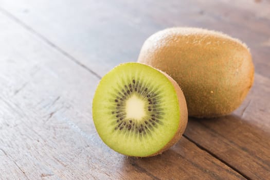 Kiwi fruit on brown wooden background, stock photo