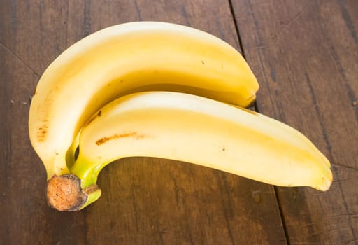 Banana on brown wooden background, stock photo