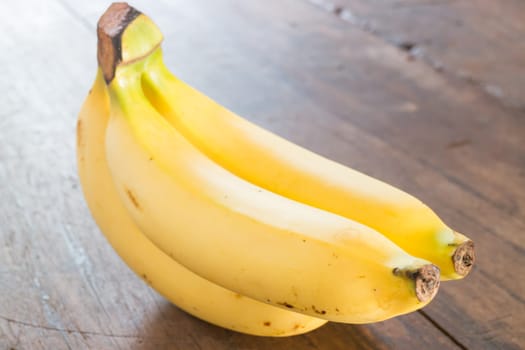 Banana on brown wooden background, stock photo