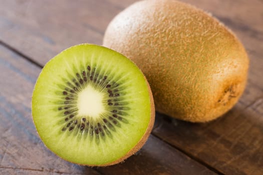 Kiwi fruit on brown wooden background, stock photo