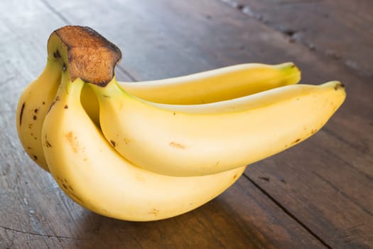 Banana on brown wooden background, stock photo